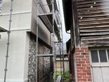 a man on a scaffold working on the side of a building