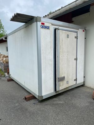 a large white container sitting outside of a building