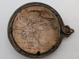 a picture of an old pocket watch with writing on it