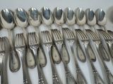 a lot of silver spoons and forks on the table