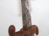 a close up of a rusty metal hook on a wall
