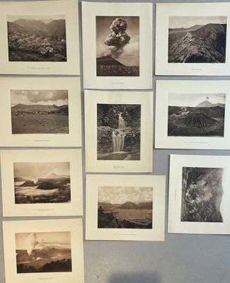 several black and white photographs are hanging on a wall in a room