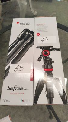 La boîte du trépied est posée sur la table, à côté de l'appareil photo.