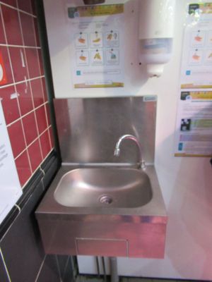 a stainless steel sink in a public restroom