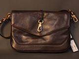 a close up of a brown purse on a table