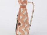 a small vase with a design on it on a white surface