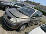 cars parked in a parking lot with a damaged hood on