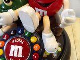 a candy machine with m & m ' s on top of it