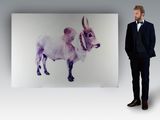 a man standing in front of a painting of a cow