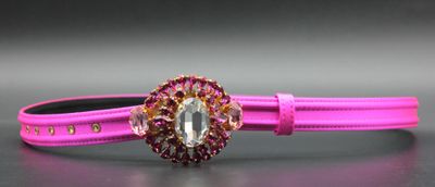 pink leather bracelet with a crystal stone center and a gold clasp