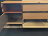 a wooden cabinet with drawers and a laptop on top of it