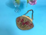 a small purse sitting on a table next to a vase of flowers