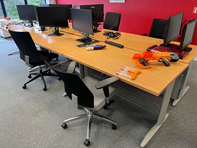 many computers on the desk in this office