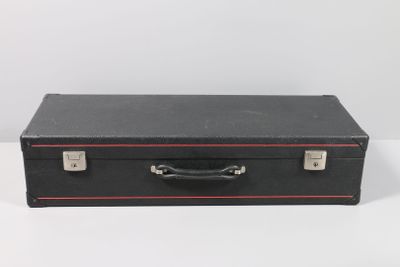 a black suitcase sitting on a white surface