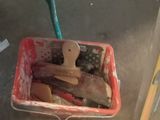 a red basket filled with wooden spoons and spatulas