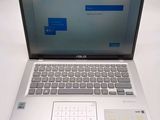 the laptop is open on the table with a keyboard and mouse