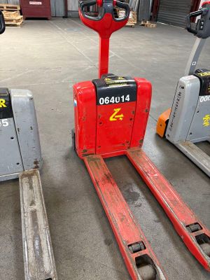 two forklifts that are sitting next to each other in a warehouse