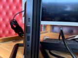 a computer sitting on top of a wooden desk next to a monitor