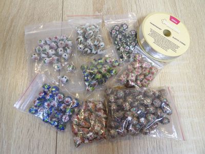 a bag of beads and a spool of thread on a table