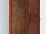 a grandfather clock sitting on top of a tall wooden grandfather clock