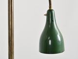 a green lamp that is next to a gold pole