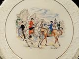 a plate with a picture of a group of people riding horses
