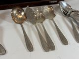 five spoons and two spoons sitting on a table