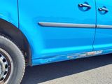 a blue van that is parked on the side of the road
