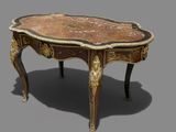 a small table with a marble top on a gray surface