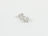 a close up of a single diamond ring on a white surface