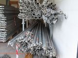 a large pile of steel pipes in a warehouse