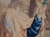 painting of a woman holding a flower in front of a man with a crown