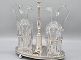 a silver plate with two glass vases on it