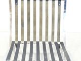 a white and black striped chair sitting on a white floor
