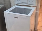 a small white chest freezer in the corner of a kitchen