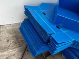 a stack of blue plastic bins sitting on a pallet