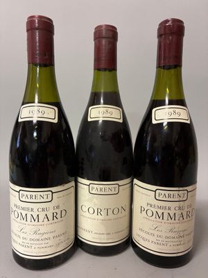 three bottles of wine are lined up on a table