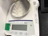 a digital scale with a measuring device on top of it