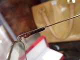 a close up of a pair of glasses and a purse