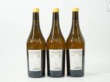 trois bouteilles de vin posées l'une à côté de l'autre sur une table