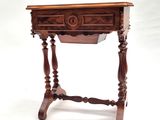 an old wooden table with a drawer on top of it