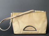 an image of a beige purse with a strap on it