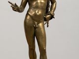 bronze statue of a male nude torsoed man holding a knife
