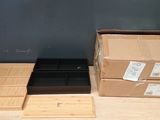 two boxes on the table and one box on the floor