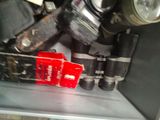 a red box that is sitting on top of a metal shelf