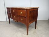 an antique chest of drawers with marble top in a room
