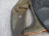 a pair of boots sitting on the ground next to a pair of boots