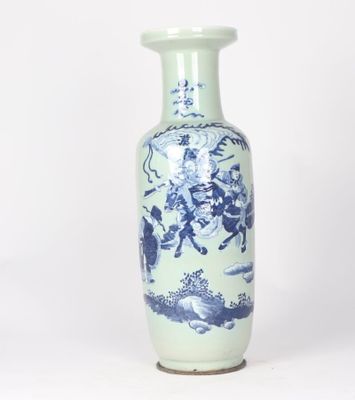 a blue and white vase sitting on a white surface