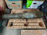 a metal pipe that is sitting on the floor