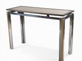 une image d'une table avec un plateau en verre et des pieds en métal
